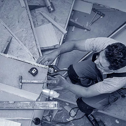Ein Tischler arbeitet an einer Treppe.